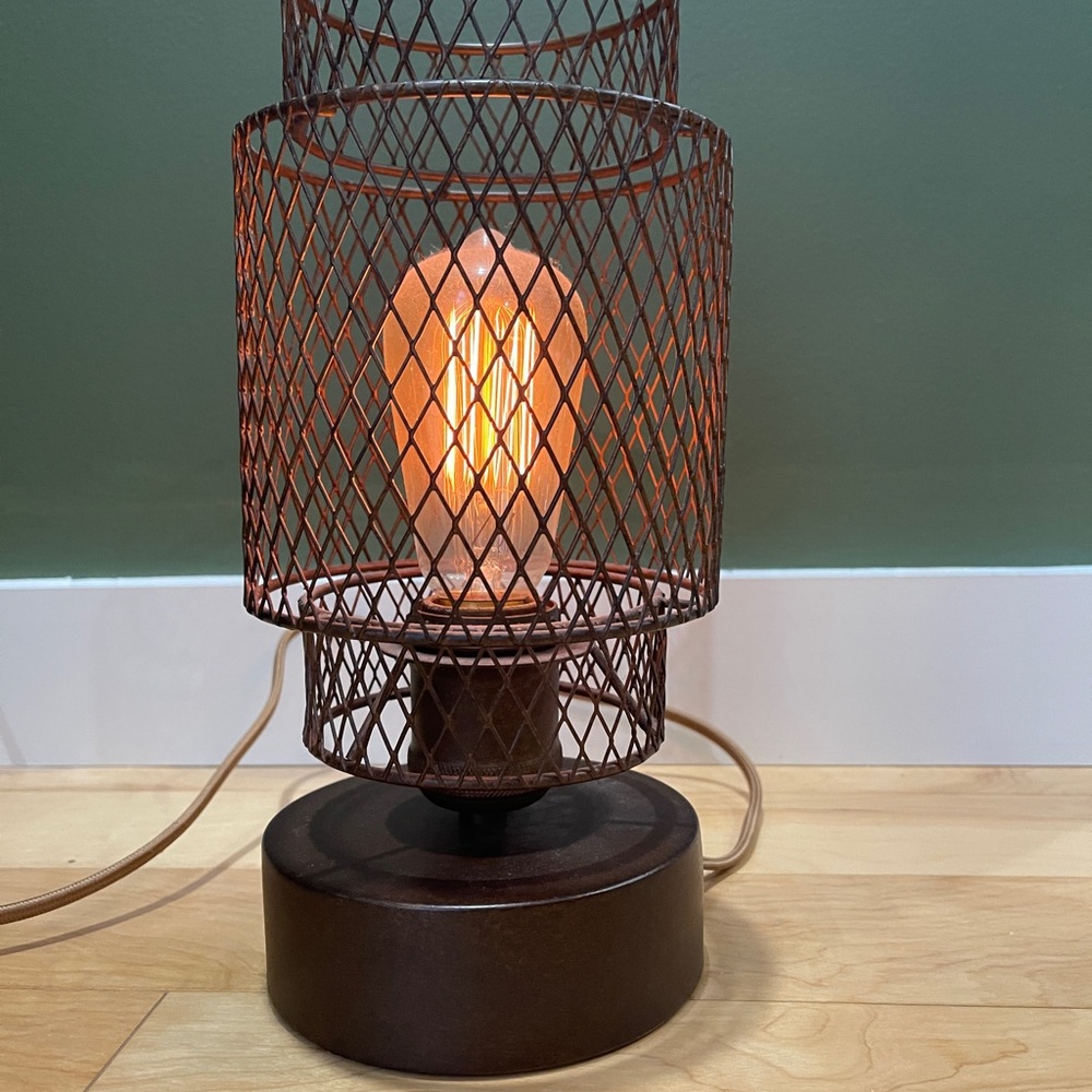Brown Lantern with Intricate Wire Design and Warm Glow